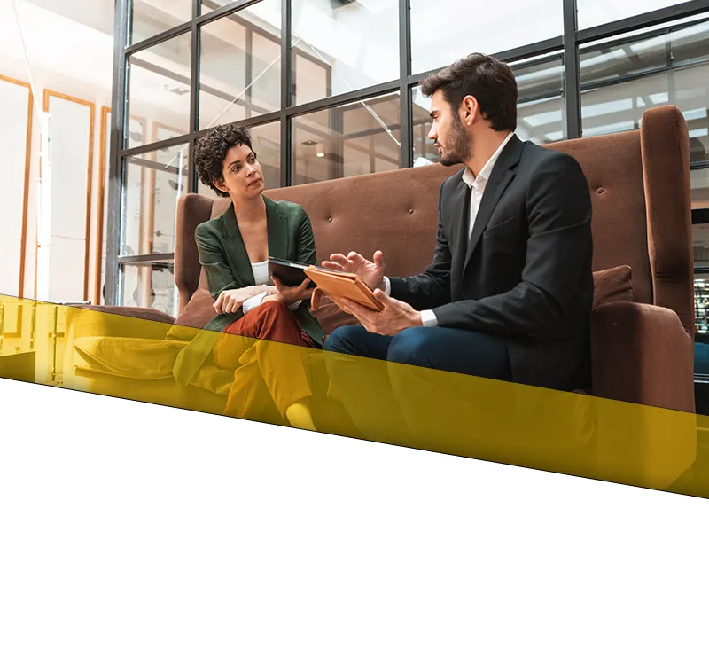 loutel law home slide 01 mobile Two attorneys having a discussion in an office setting at a conference area.