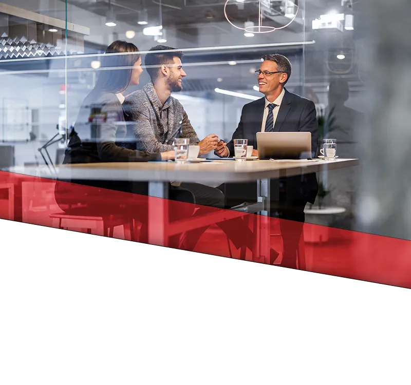 loutel law home slide 03 mobile A meeting between a male attorney and his clients.